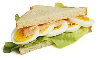 Egg sandwich on white bread, with meat